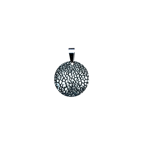 Round dog nose print pendent with white background.